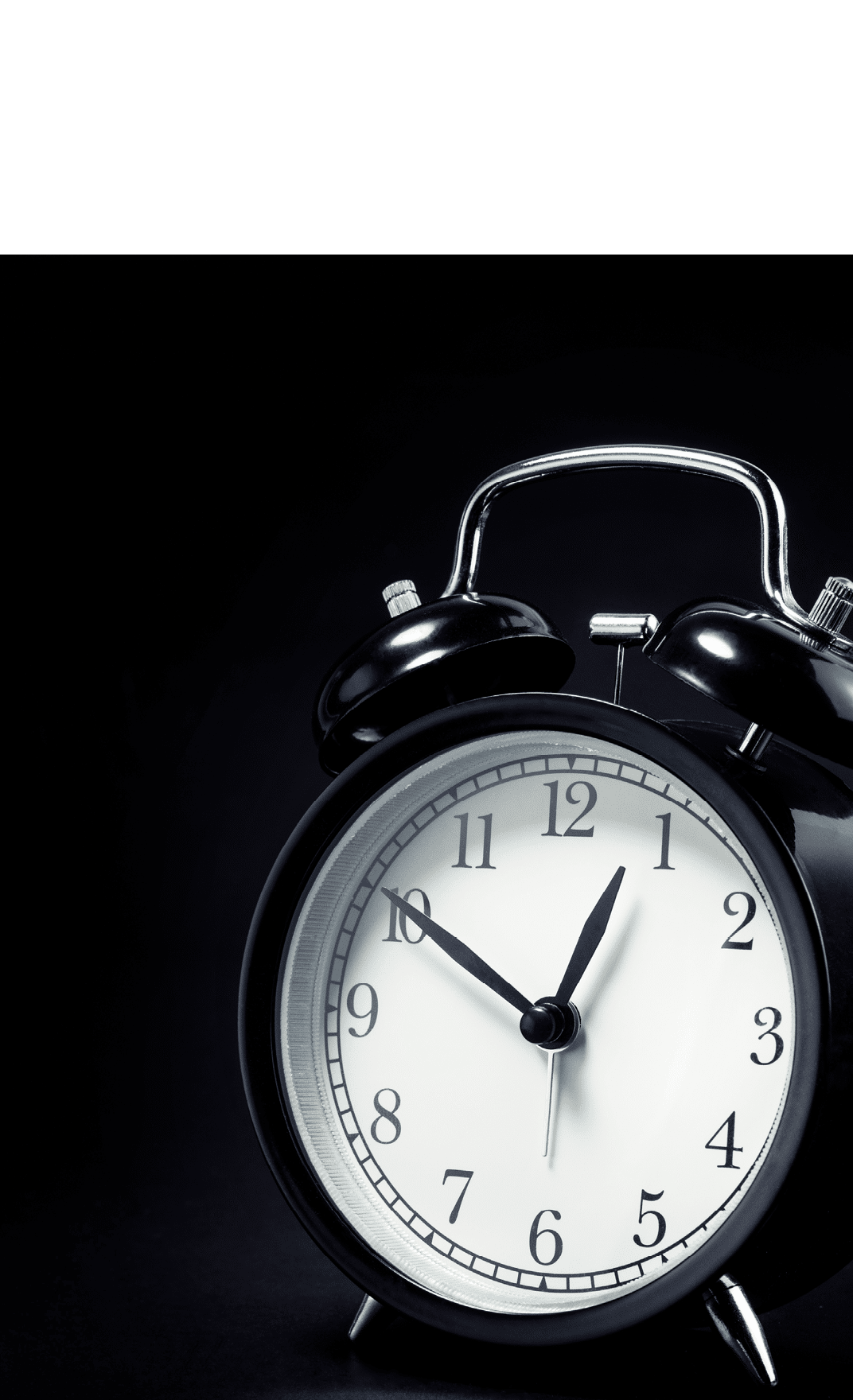 black retro alarm clock in dark background For time concept 