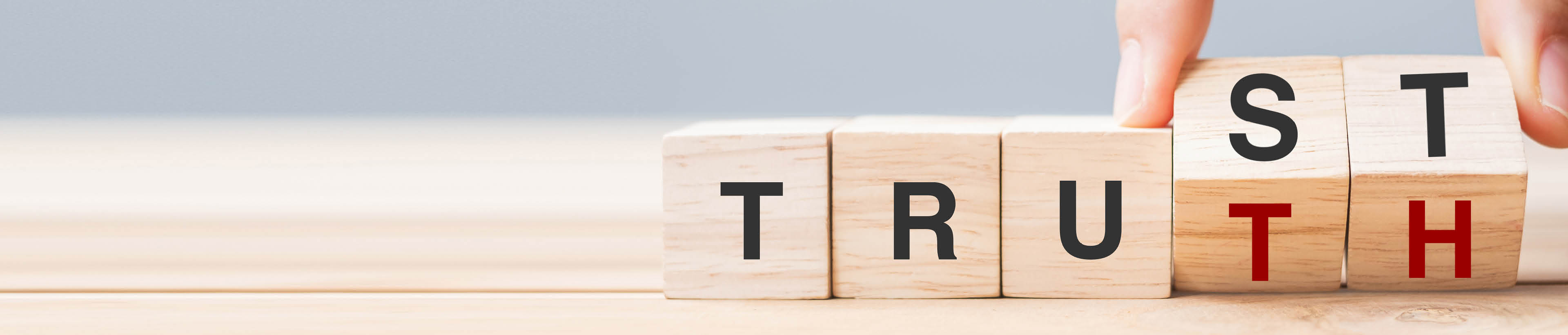 Business man hand change wooden cube block with TRUST and TRUTH business word on table background. Trustworthy, faith, beliefs and honesty concept
